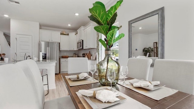 dining area with recessed lighting, visible vents, and light wood-style floors
