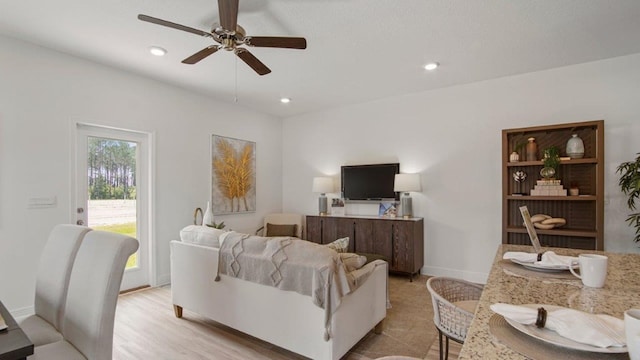 living room with baseboards, ceiling fan, and recessed lighting