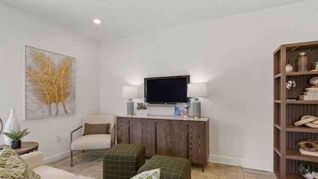 sitting room featuring baseboards and recessed lighting