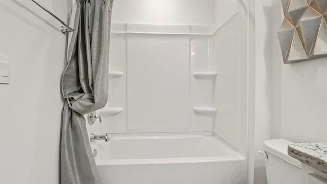 bathroom with shower / bath combo with shower curtain and toilet