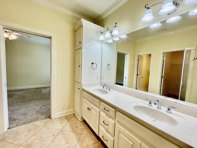 114 Brattleboro Ct, Dothan, AL 36301 - bathroom with crown molding, double vanity, tile patterned flooring, baseboards, and a ceiling fan