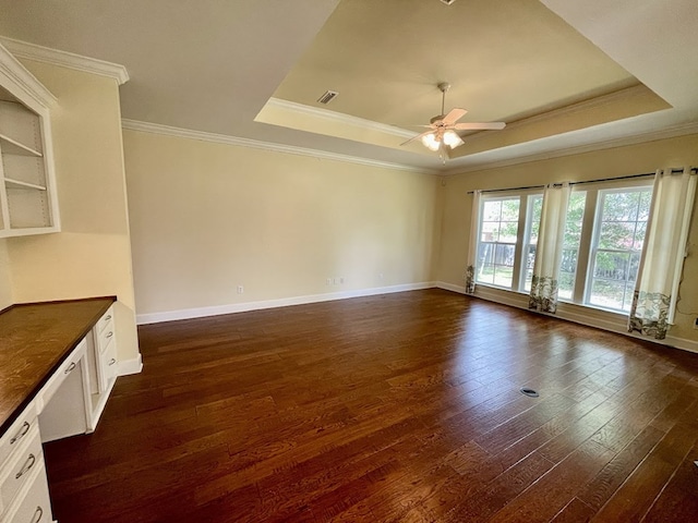 114 Brattleboro Ct, Dothan, AL 36301 - empty room featuring a tray ceiling, ornamental molding, dark wood finished floors, ceiling fan, and baseboards