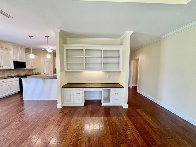 114 Brattleboro Ct, Dothan, AL 36301 - kitchen with open shelves, dark countertops, dark wood finished floors, backsplash, and ornamental molding