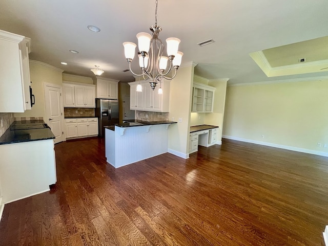 114 Brattleboro Ct, Dothan, AL 36301 - kitchen with stainless steel refrigerator with ice dispenser, ornamental molding, a peninsula, dark countertops, and white cabinetry
