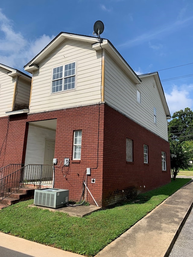 view of property exterior featuring a yard and cooling unit