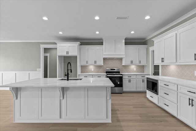 195 County Road 711, Enterprise, AL 36330 - kitchen with stainless steel electric range, a sink, crown molding, built in microwave, and white cabinets