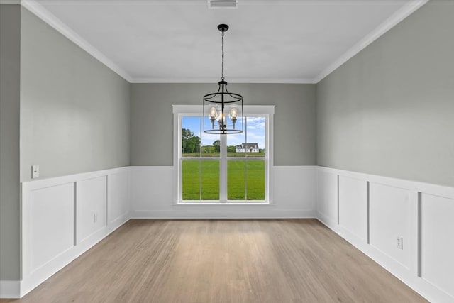 195 County Road 711, Enterprise, AL 36330 - spare room with light wood-style flooring, a wainscoted wall, a chandelier, and crown molding