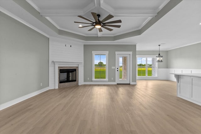 195 County Road 711, Enterprise, AL 36330 - unfurnished living room with a brick fireplace, ornamental molding, a ceiling fan, a chandelier, and light wood-style floors