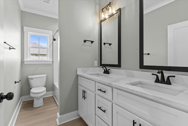 195 County Road 711, Enterprise, AL 36330 - bathroom with wood finished floors, toilet, baseboards, double vanity, and washtub / shower combination
