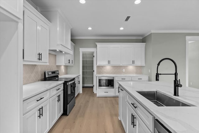 195 County Road 711, Enterprise, AL 36330 - kitchen featuring appliances with stainless steel finishes, a sink, white cabinets, tasteful backsplash, and crown molding