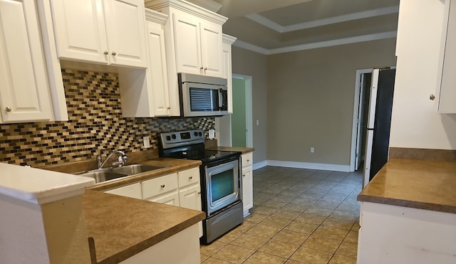 103 Whaley Ct, Ashford, AL 36312 - kitchen featuring stainless steel appliances, tasteful backsplash, light tile patterned flooring, white cabinetry, and crown molding