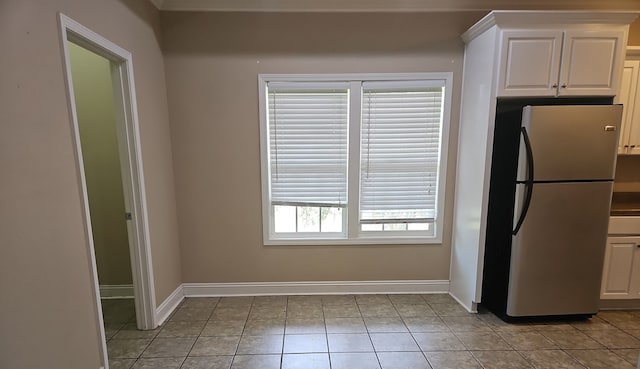 103 Whaley Ct, Ashford, AL 36312 - kitchen with freestanding refrigerator, white cabinetry, and light tile patterned flooring