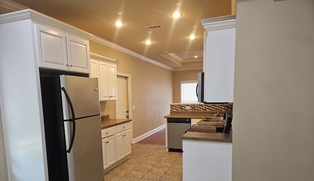 103 Whaley Ct, Ashford, AL 36312 - kitchen featuring appliances with stainless steel finishes, ornamental molding, dark countertops, white cabinetry, and recessed lighting