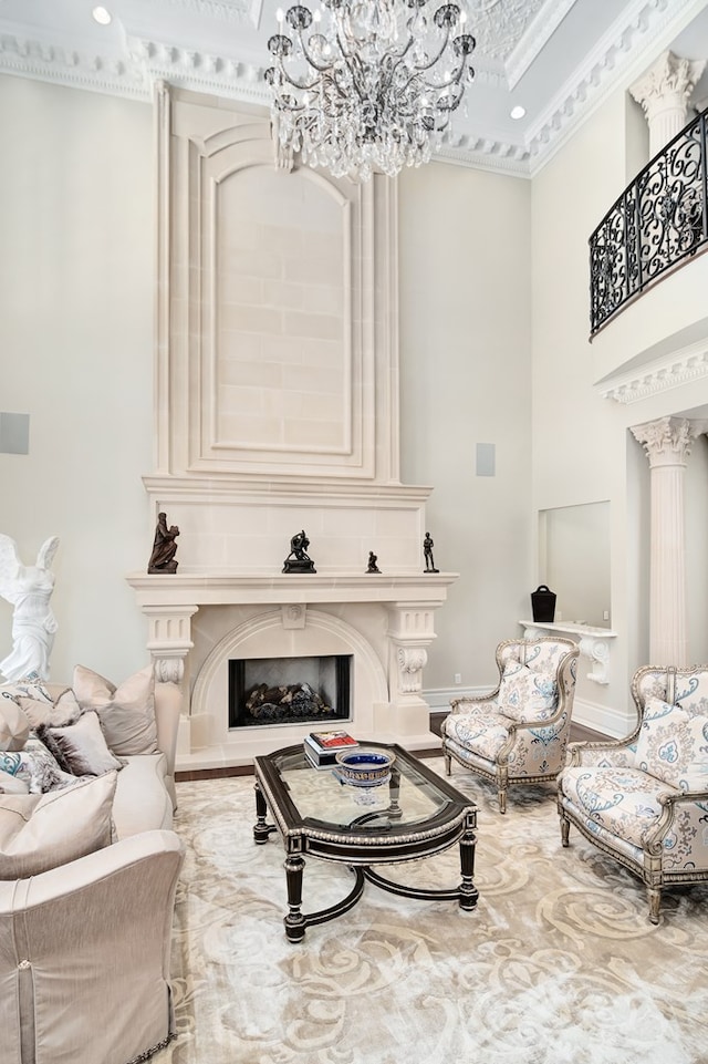 living room with crown molding, a fireplace, and an inviting chandelier