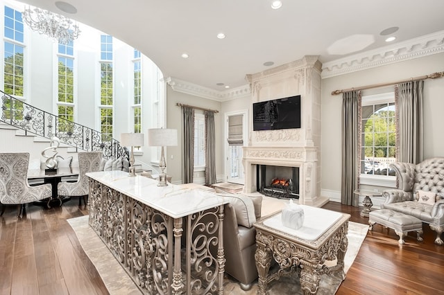 living room featuring crown molding, a fireplace, and dark hardwood / wood-style floors