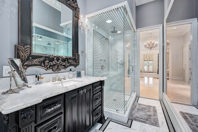 bathroom with a chandelier, vanity, an enclosed shower, and ornamental molding