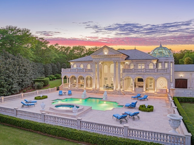 exterior space with an in ground hot tub and a patio