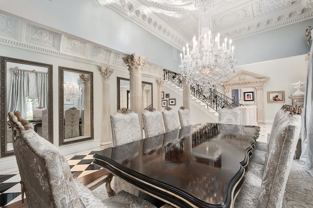 dining room with a high ceiling, crown molding, a notable chandelier, wood-type flooring, and decorative columns