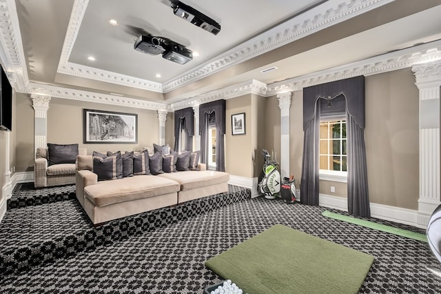 carpeted cinema room featuring a raised ceiling, ornate columns, and crown molding