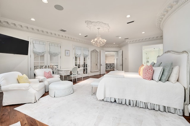 bedroom featuring a chandelier, hardwood / wood-style floors, and ornamental molding