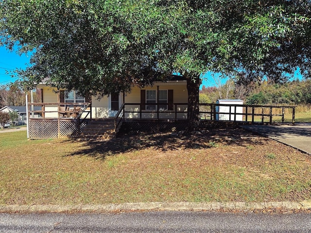 view of front of house with a porch and a front yard