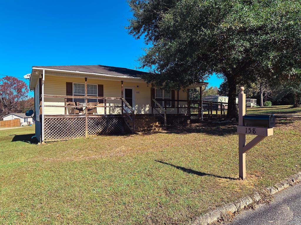 view of front of house with a front yard and covered porch