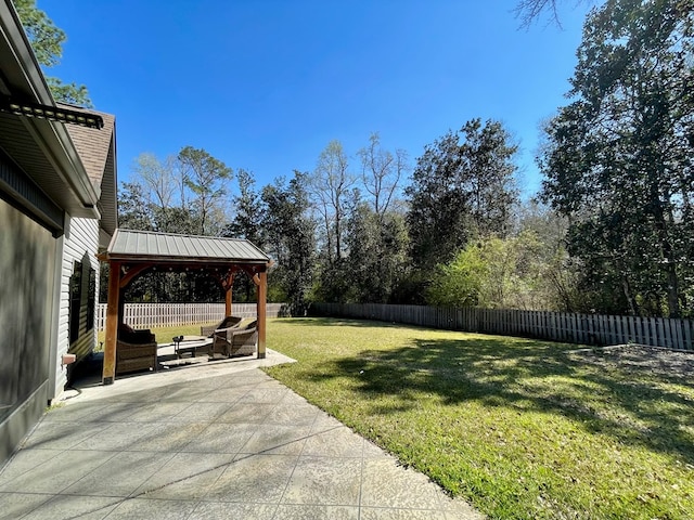 view of yard featuring a gazebo, a patio area, and a fenced backyard