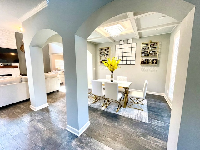 unfurnished dining area featuring arched walkways, coffered ceiling, baseboards, and wood finished floors