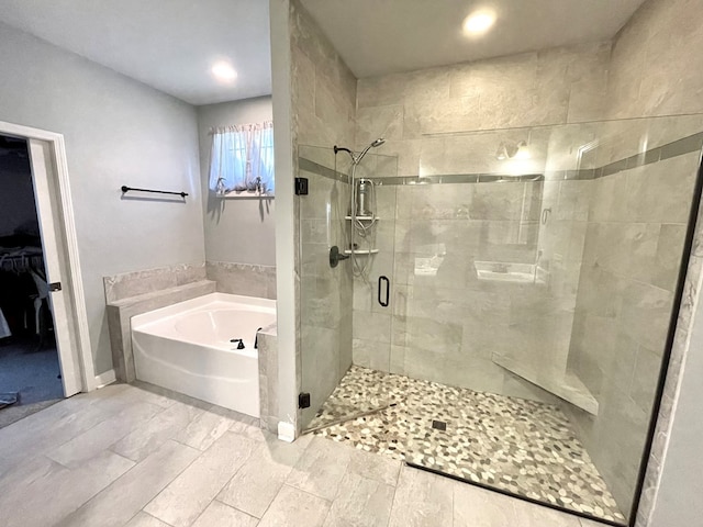 bathroom featuring a garden tub and a stall shower