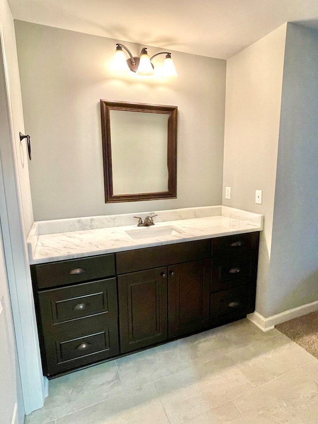 bathroom featuring baseboards and vanity
