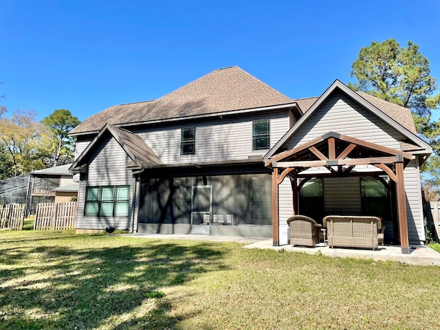 rear view of property with a lawn, fence, a gazebo, a shingled roof, and an outdoor hangout area