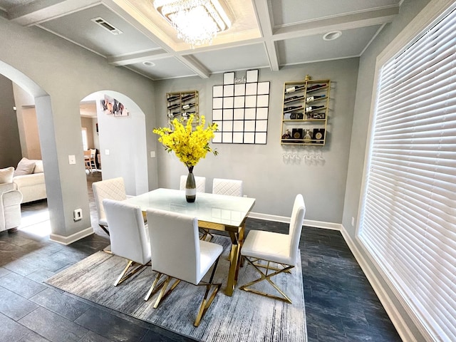 dining room featuring arched walkways, beam ceiling, coffered ceiling, and baseboards