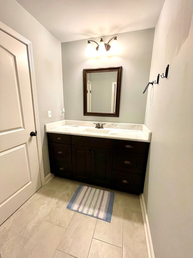 bathroom with vanity and baseboards