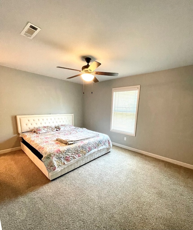 bedroom featuring visible vents, carpet flooring, baseboards, and ceiling fan