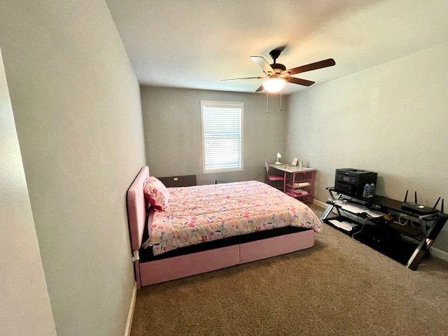 carpeted bedroom featuring baseboards and ceiling fan