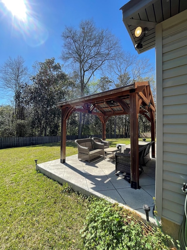 view of yard featuring a patio area, outdoor lounge area, a gazebo, and fence