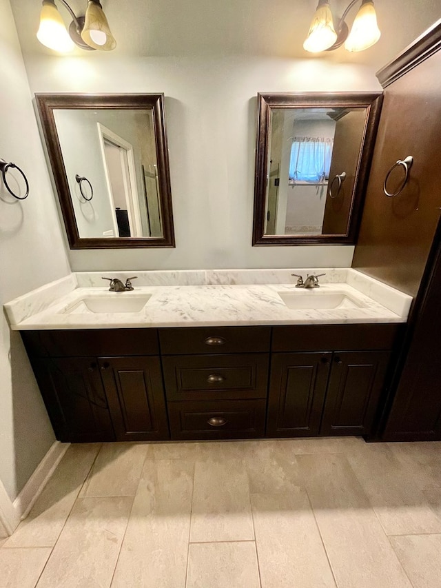 bathroom featuring a sink and double vanity