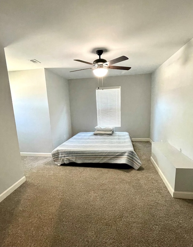 carpeted bedroom featuring visible vents, baseboards, and ceiling fan