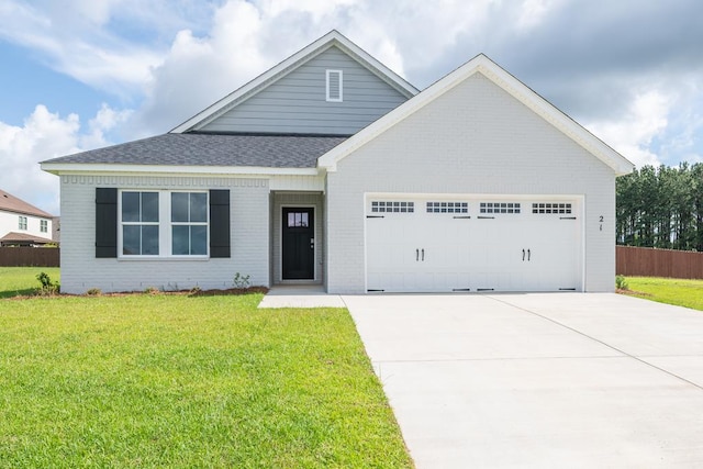 21 Popcorn Cir, Rehobeth, AL 36301 - view of front of house featuring an attached garage, brick siding, concrete driveway, and roof with shingles