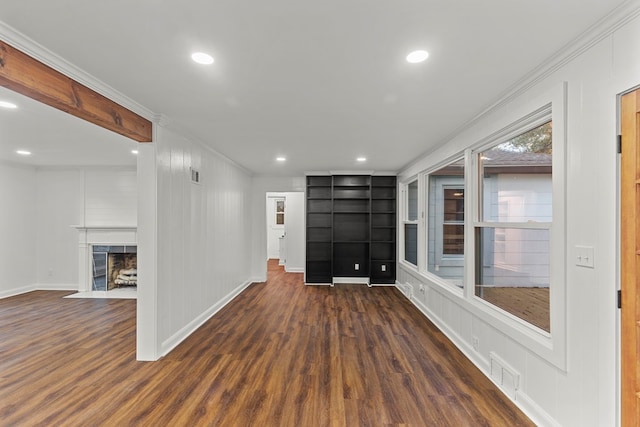 interior space featuring a fireplace, dark hardwood / wood-style floors, and crown molding