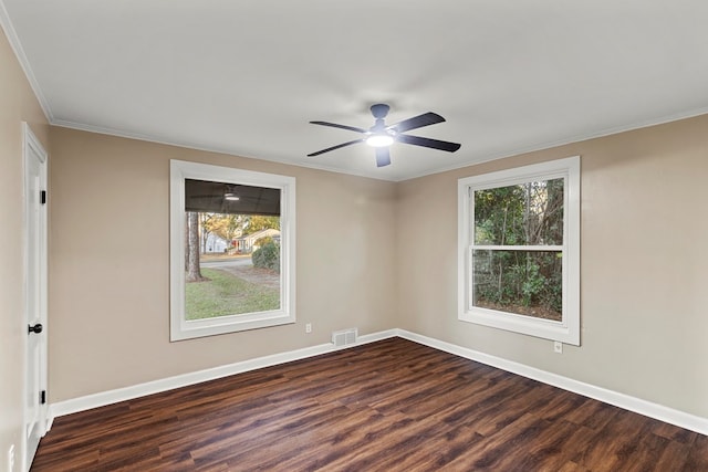 unfurnished room with ceiling fan, dark hardwood / wood-style floors, and ornamental molding