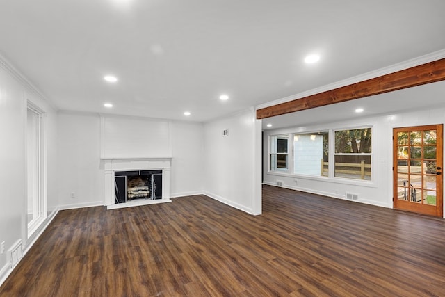 unfurnished living room featuring dark hardwood / wood-style floors, ornamental molding, and a fireplace