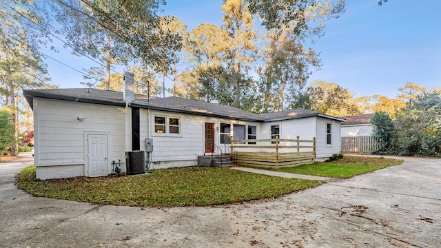 rear view of house featuring central air condition unit