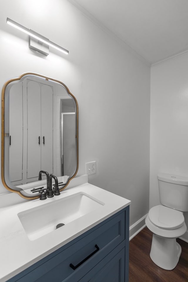 bathroom featuring hardwood / wood-style floors, vanity, and toilet