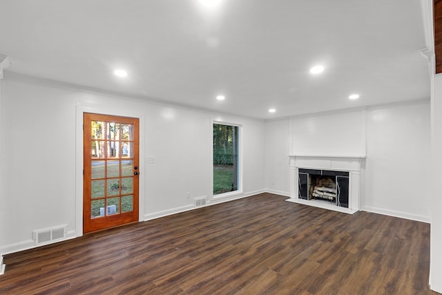 unfurnished living room with crown molding and dark wood-type flooring