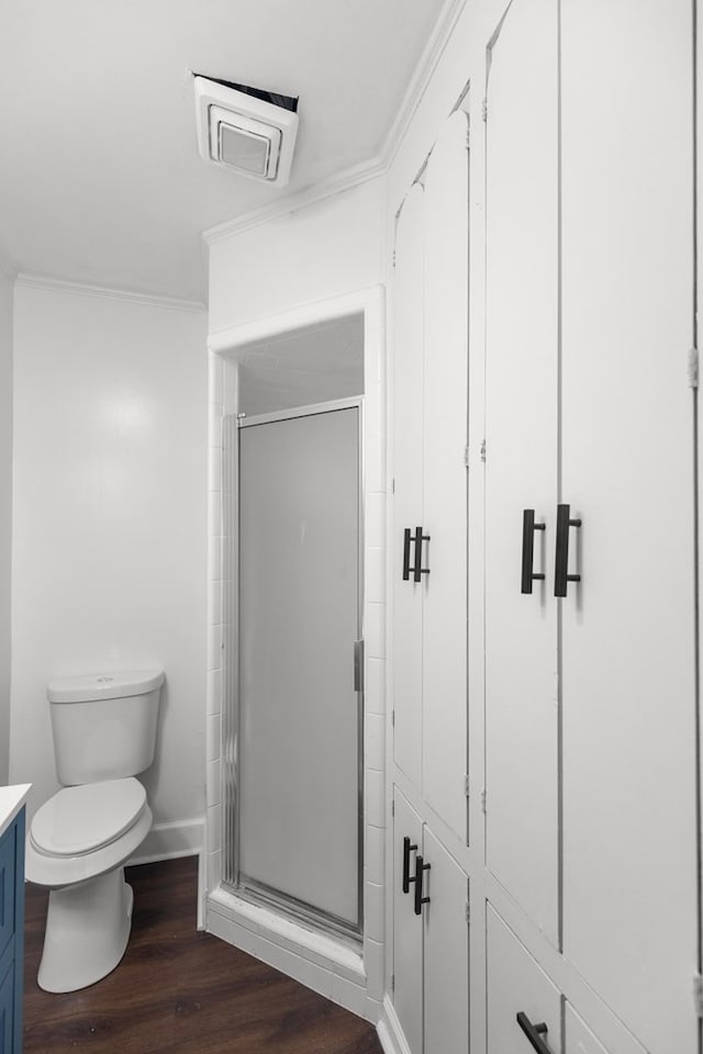 bathroom with wood-type flooring, vanity, toilet, and walk in shower