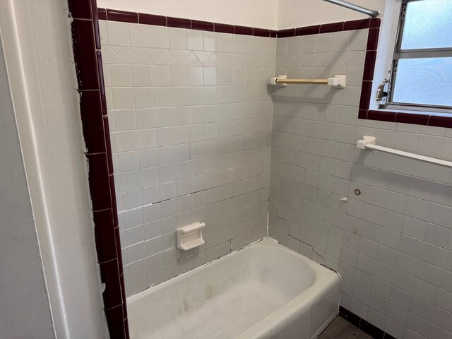 full bathroom with bathtub / shower combination and tile walls