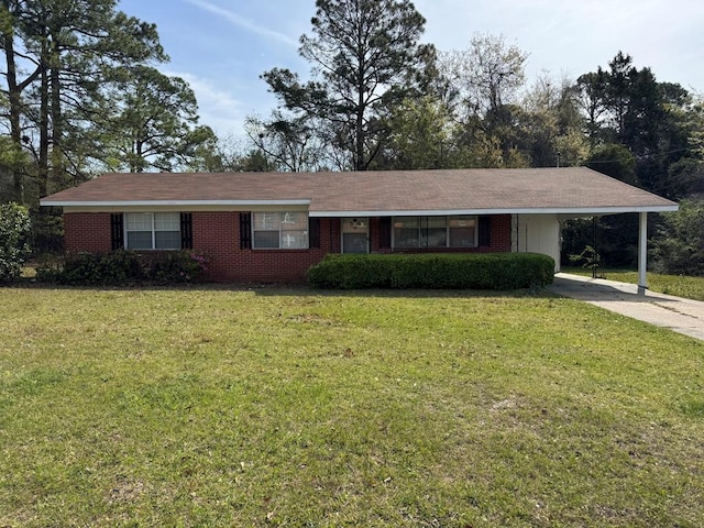 single story home with an attached carport, a front yard, brick siding, and concrete driveway