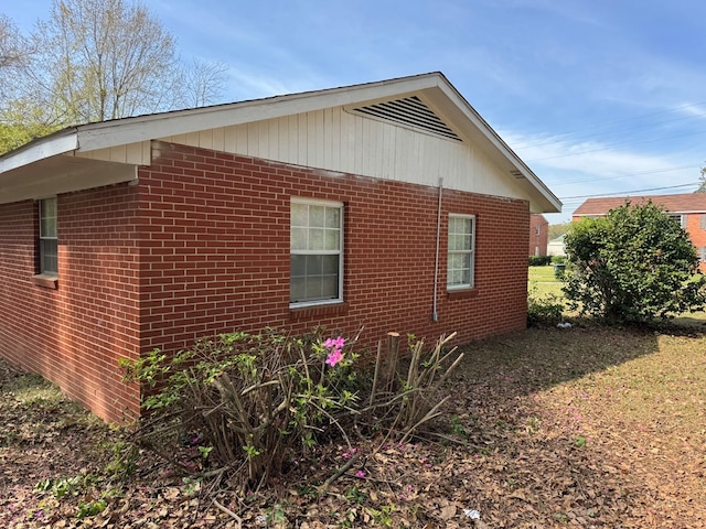 view of side of property with brick siding