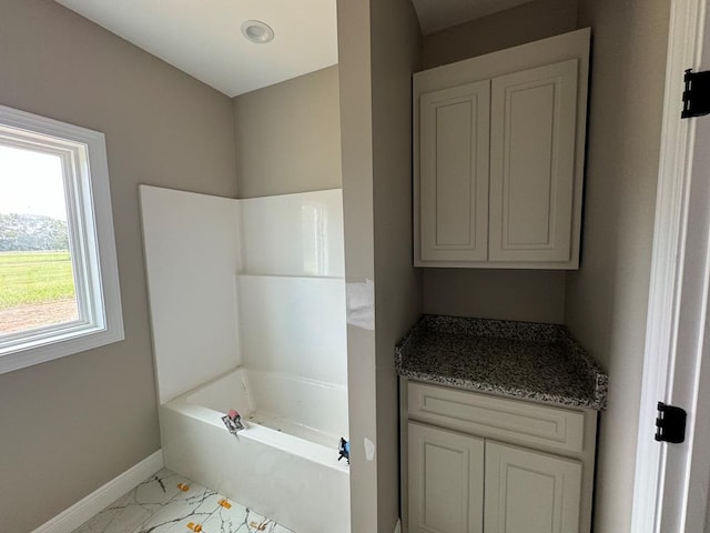 bathroom featuring a tub and vanity